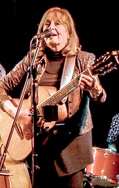 Carol Bean Carol Bean singing and playing acoustic guitar onstage